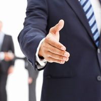 Handshake gesture by person in suit.