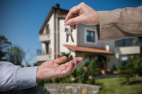 Handing over house keys outside home.
